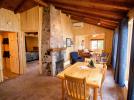 Dining and living area with wood burning fireplace.