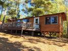 Exterior of Sunset View showing a one level cabin with some tree coverage.