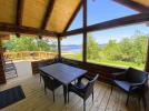 Covered porch area with seating, overlooking the beach. 