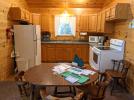 Kitchen and dining room with a standard refrigerator, stove, and dishwasher.