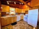 Kitchen with stove, refrigerator and dishwasher.