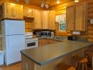 Kitchen with a standard refrigerator, stove and dishwasher.