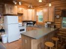 Kitchen with refrigerator, stove, dishwasher and breakfast bar.