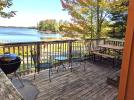 Deck area with a picnic table, charcoal grill and views of the beach.