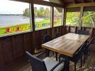 Screened porch area with a patio set and views of the beach and Lake Vermilion.