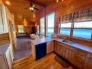 Kitchen with stove, refrigerator, dishwasher and views of the lake.