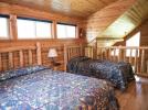 Loft bedroom with a queen and twin bed.
