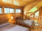 Loft bedroom with a queen and twin bed.