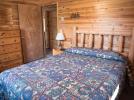 Main floor bedroom with a queen bed.