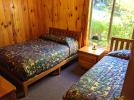 Main floor bedroom 2 with a double and twin bed.