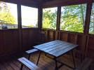 Screened porch area with a picnic table.