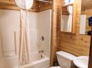 Bathroom with a standard tub shower.