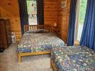 Living room with a queen and twin bed.