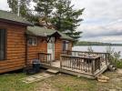 Deck area with a picnic table, charcoal grill, and views of the lake.