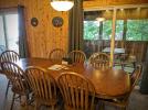 Large dining room table with patio doors to the screened porch.