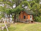 Exterior or Minnesota, with firepit nearby, swinging chair, and views of the lake.