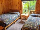 Main floor bedroom with a double and twin bed.