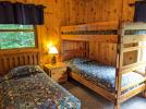 Upstairs bedroom with a twin and set of twin bunk beds.