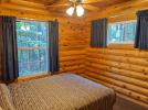 Main floor living room with a queen bed.