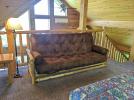 Loft area with a queen futon and two story views.