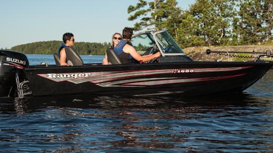 Group of young adults smiling in a rental boat on Lake Vermilion