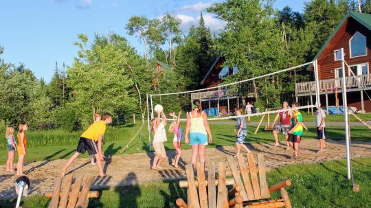 Group of children playing beach volleyball