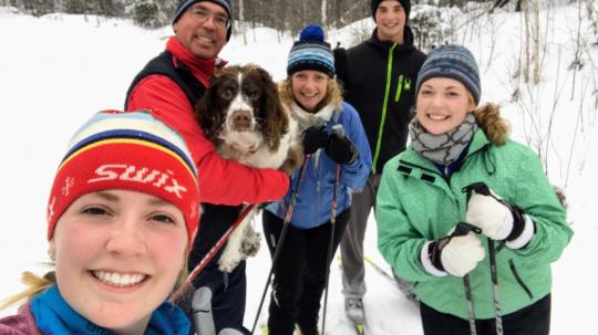 The Hanson family cross-country skiing during winter at Pehrson Lodge
