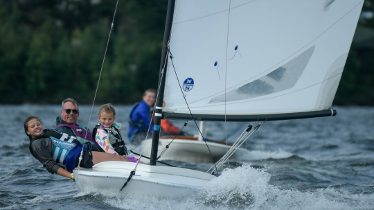 Pehrson Lodge Owner Eric Hanson takes a guest for a ride on the MC-scow