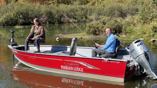 Trolling down the shoreline with a Lund fishing boat.