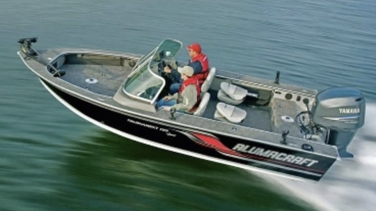 Two men driving Alumacraft boat down the lake