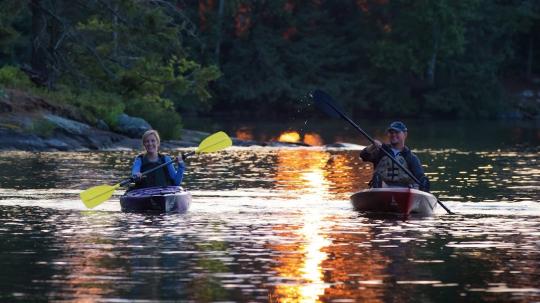 Couple going for a romantic, evening kayak.