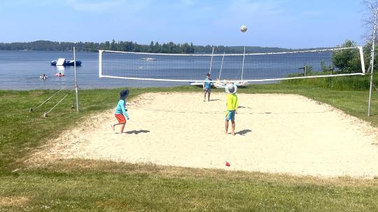 Group of children playing beach volleyball