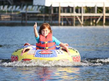 Girl enjoys tubing on a sunny day on Lake Vermilioin