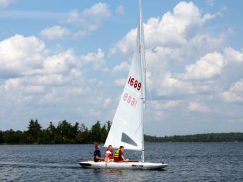 Group of three young boys sailing on MC Scow