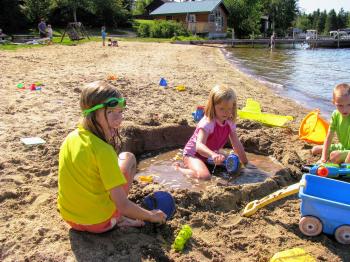 Children making a sandcastle at the Pehrson Lodge beach