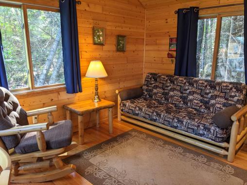 Cozy living room with a double futon and rocking chair.