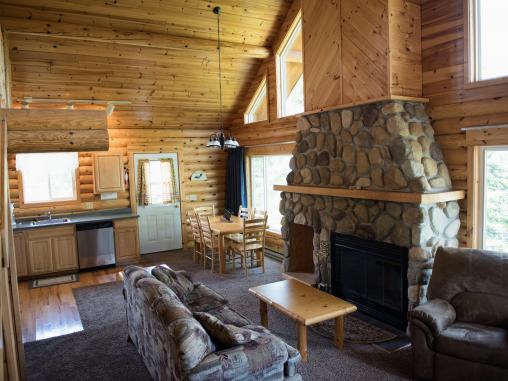 Livingroom and dining room with large picture windows of the lake.