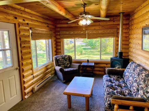 Living room with futon, chair and views of the lake.