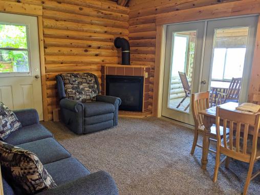 Living room with a couch, recliner, gas fireplace, and access to the 3 season porch.