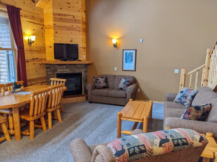 Living room with ample seating, gas fireplace and TV with satellite programing.