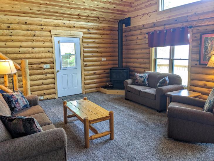 Living room with couch, loveseat, recliner, and gas burning fireplace.