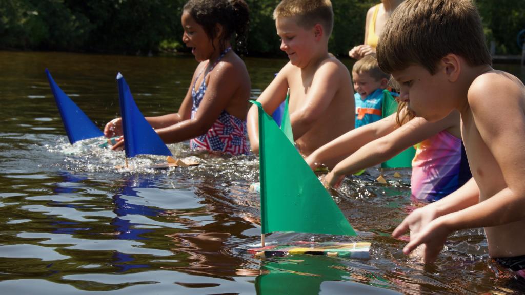 Children race their sailboats during Kids Program at Pehrson Lodge
