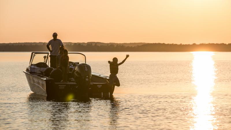 Father and son in boat on Lake Vermilion at sunset.