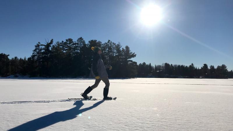 Man snowshoes on Lake Vermilion