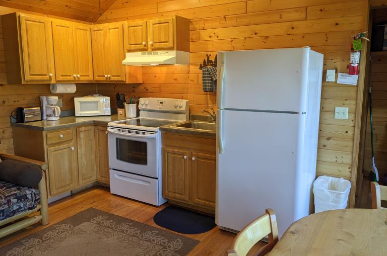 Kitchen with a refrigerator and stove.