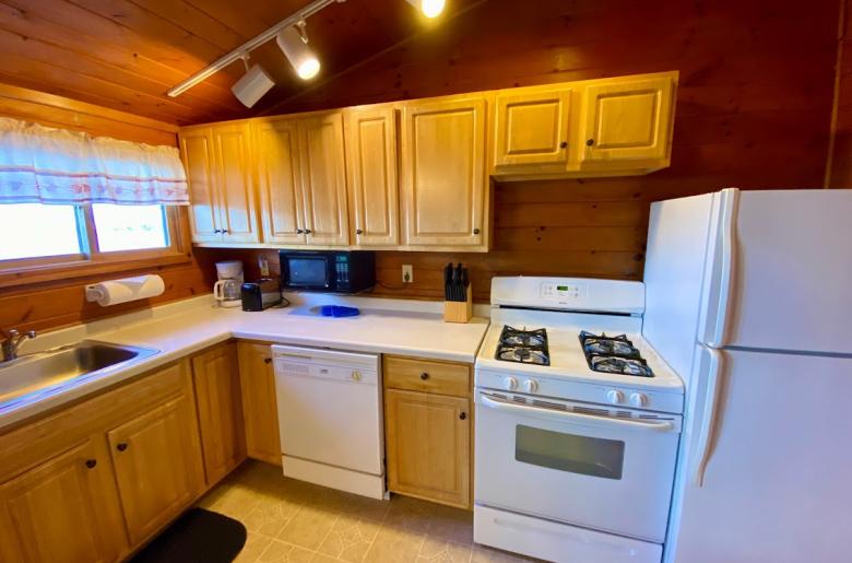 Standard kitchen with refrigerator, stove, and dishwasher.