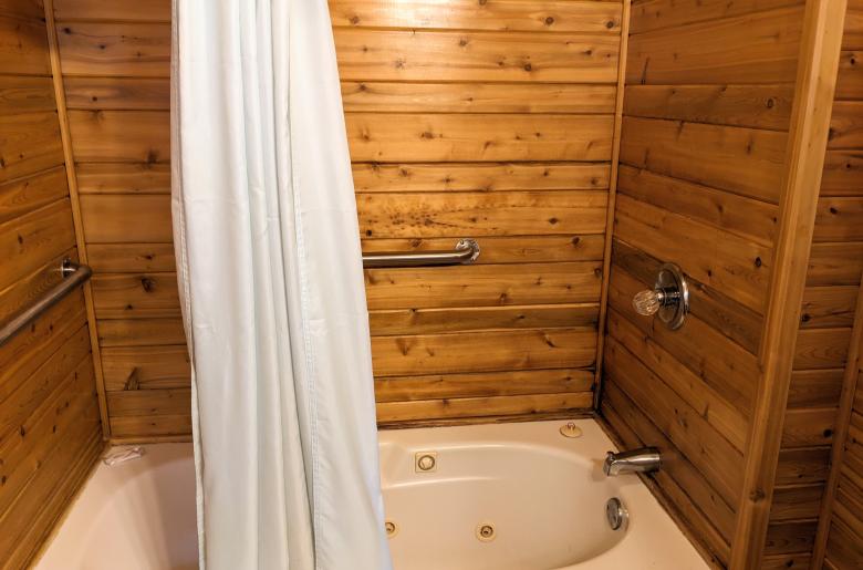 Bathroom with a whirlpool tub/shower.