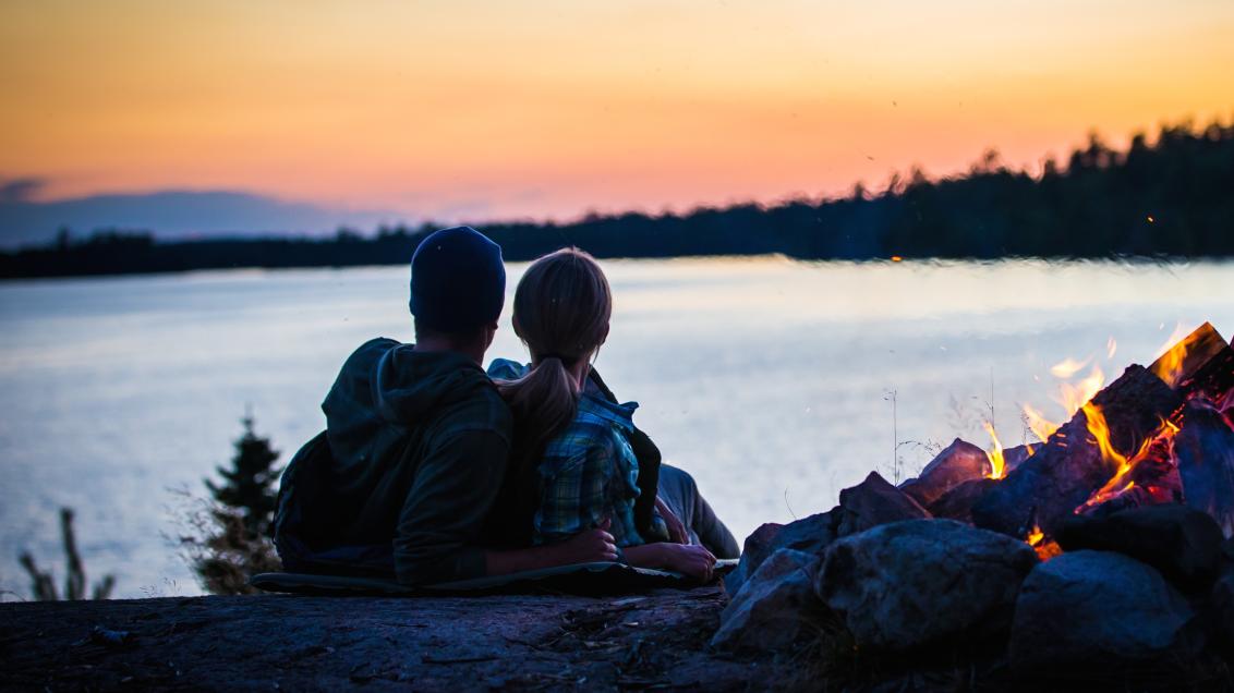 Couple watches the sunset on Lake Vermilion