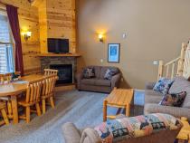 Living room with couch, loveseat, recliner, gas fireplace, and TV with streaming capabilities.
