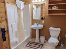 Main floor bathroom with wide door and easy access shower and sink.